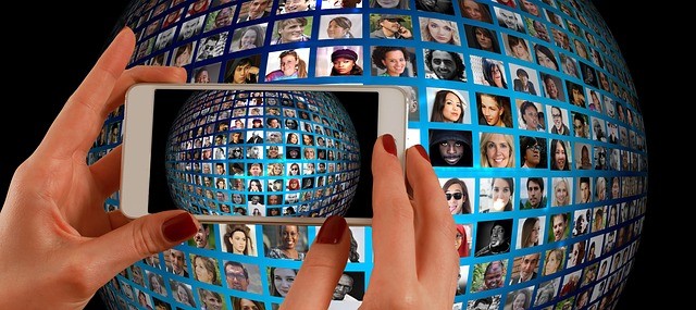 smartphone taking a photo of a sphere with photos of people