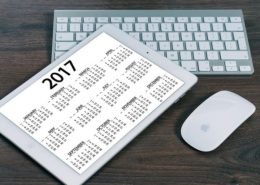 2017 calendar displayed on an ipad on top of a wooden desk