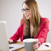 woman trying to drink coffee while working