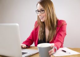 woman trying to drink coffee while working
