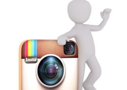 a white doll leaning on the instagram icon