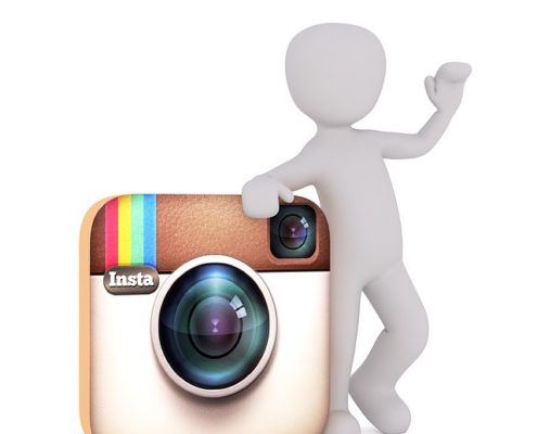 a white doll leaning on the instagram icon