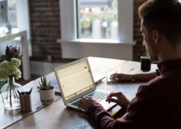 man writing an engaging content in a good looking cafe