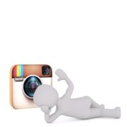 A white doll sleeping in front of the instagram logo