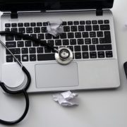 White paper trash and a stethoscope on a computer