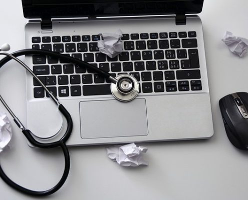 White paper trash and a stethoscope on a computer