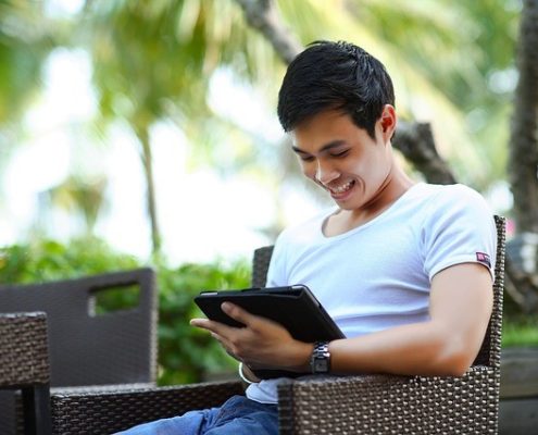 Asian man with a tablet device on a vacation