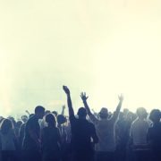 A crowd of people enjoying a music event in a foggy place