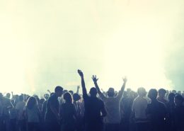 A crowd of people enjoying a music event in a foggy place